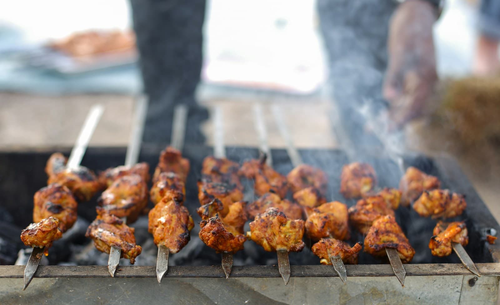 Skewers of meat on a charcoal grill