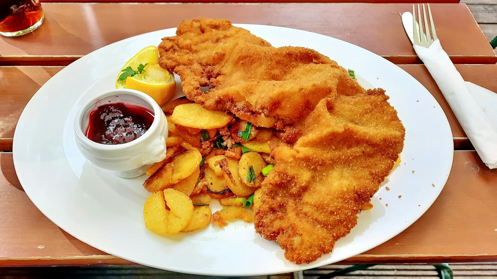 Schnitzel with fried potatoes and lingonberry sauce