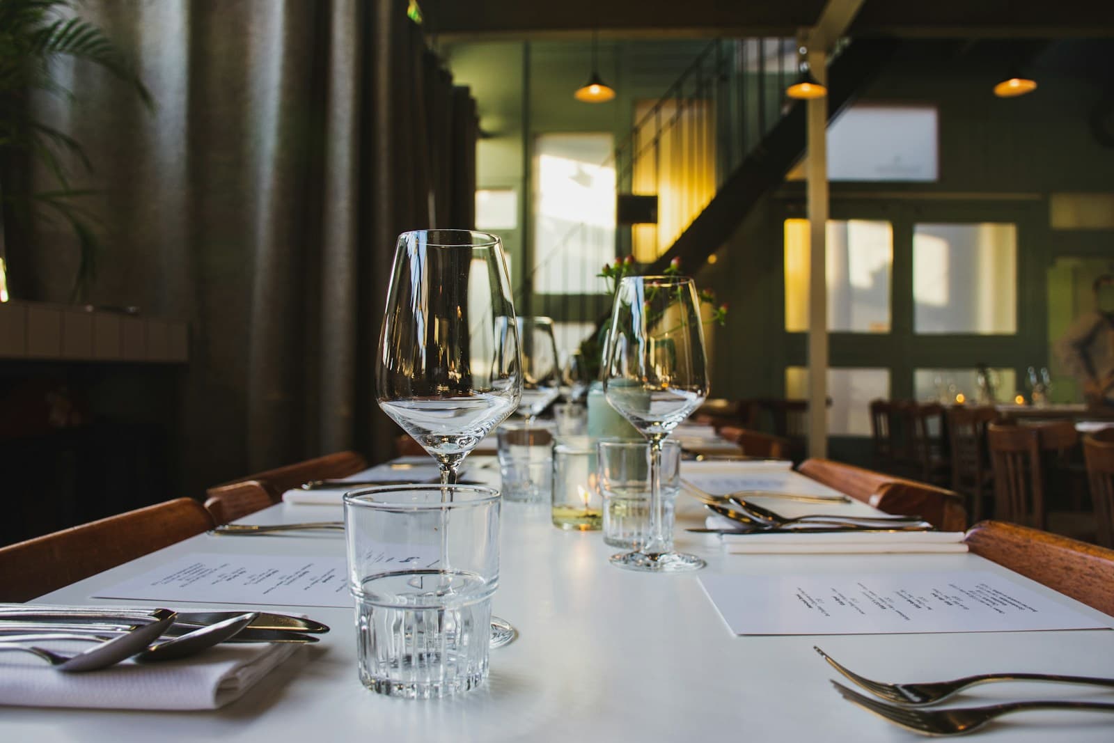 A long table set for dinner in a restaurant dining room